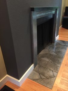 A dark paint color done in a flat sheen on a fireplace bump out